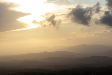 Fototapeta na wymiar View of a beautiful golden sunset over a mountain range