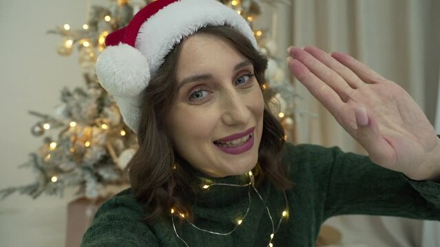 woman calls her friends via video conference call wishing Merry Christmas