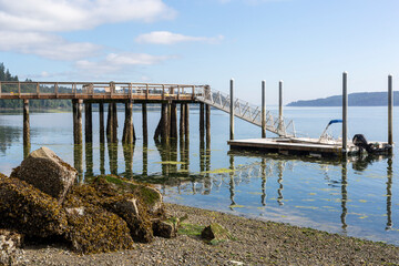Fototapeta premium boat parked on a pier in the bay against the backdrop of mountains
