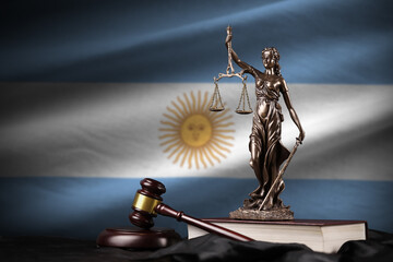 Argentina flag with statue of lady justice, constitution and judge hammer on black drapery. Concept...