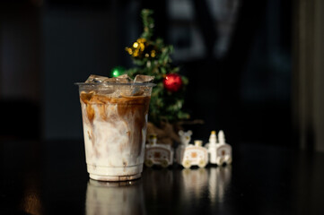 ice latte coffee in plastic glass on black table at cafe​