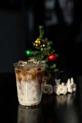 ice latte coffee in plastic glass on black table at cafe​