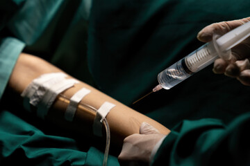 Doctor giving injection to patient before surgery.  Surgery and emergency concept