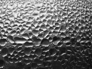 Glass with raindrops on a dark background