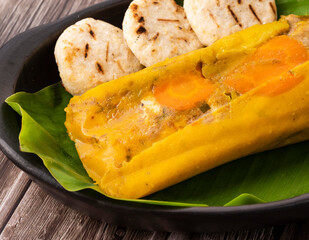 Steamed tamal wrapped in banana leaves - Traditional Colombian Gastronomy