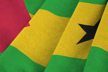 Sao Tome and Principe flag with big folds waving close up under the studio light indoors. The...