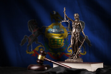 Pennsylvania US state flag with statue of lady justice, constitution and judge hammer on black...