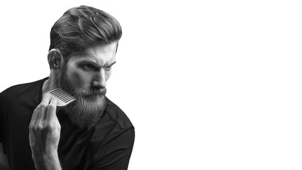 Bearded man with hair brush. Trendy and stylish beard styling and cut. Brutal young bearded man. Stylish man brushing his beard