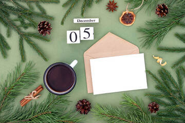 December 5. Calendar date, white blank with craft envelope, cup of tea and natural decor on green background. Hello winter. Template for your design, greeting card