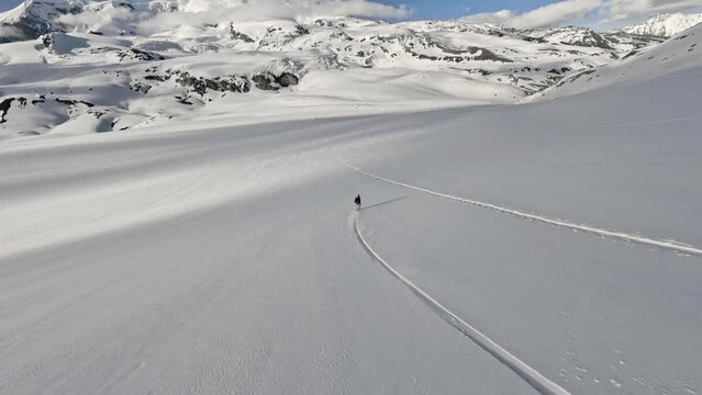 Aerial follow view extreme man snowboard freeride on snowy mountain field. FPV sport drone shot snowboarding speed ride danger fast action outdoor leisure activity hobby in 4k