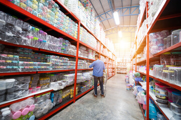 Asian man shopping. Handsome smiling young man shopping for household items with supermarket and shopping cart.