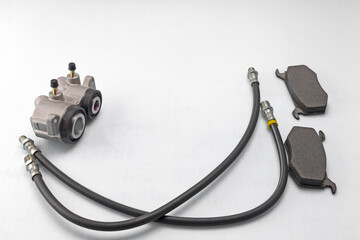 automotive parts and components of the brake system for completing mechanisms and repairing a car on a white milky background.