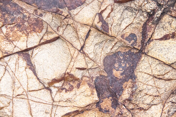Fototapeta na wymiar Natural rock texture abstract cracked brown background