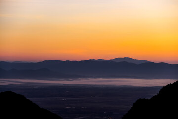 Fototapeta premium Mountains view on beautiful orange gold sky before sunrise in the morning Chiang Rai of Thailand background