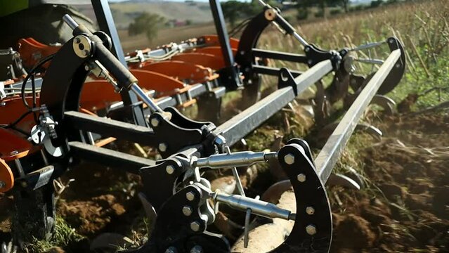 subsoiling after the sunflower harvest thanks to a subsoiler connected to a large tractor in a rural area in central Italy