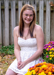 Happy young lady in a sleeveless white dress