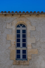 A narrow window for a stone house in France