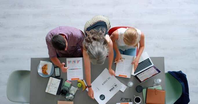 Top view of business people, marketing team and branding management planning logo, creative strategy and ideas in startup company. Designers, advertising meeting and teamwork collaboration at table