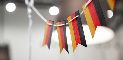 A garland of Germany national flags on an abstract blurred background
