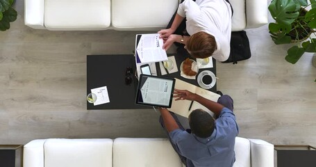 Top view, business people and timelapse of meeting, teamwork or collaboration with paper research, documents or technology. Men, women and diversity designer with tablet charts or marketing analytics - Powered by Adobe