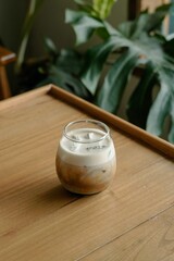 Clear Drinking Glass With Brown Liquid on Brown Wooden Table
