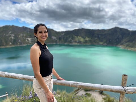 CHEERFUL LATIN WOMAN AT THE VIEWPOINT OF A LAGOON