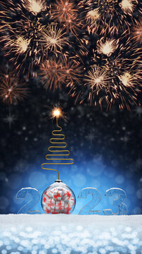 New Year card ice number 2023 on snow. Christmas tree toy in the form of ball with gifts in the form of bomb. Festive banner with salutes against the background of night abstract defocused lights.