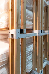 Steel holds a square timber structure in place.