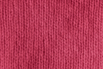 Trendy color of 2023 viva magenta. texture of knitted angora fabric. magenta wool texture. Knitted jersey background with relief pattern for wallpaper and abstract background. handmade
