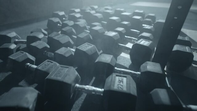 black heavy dumbbells on floor of gym, closeup view, sport activities and healthy lifestyle