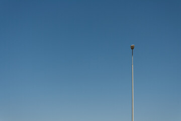 a lonely lamppost against the blue sky, a place to copy