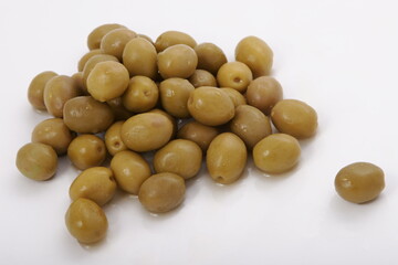 Fresh wet olives on a white surface