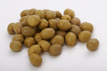 Fresh wet olives on a white surface