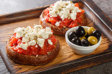 Cretan dakos is for a traditional salad from the island of Crete consists of barley rusk topped...