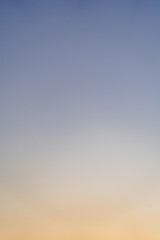 Sunset, sunrise gradual color of sky. Smooth orange blue gradient of dawn sky. Vertical background of heaven at early morning