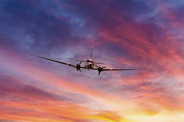 A turboprop aircraft is flying in a dramatic sky.