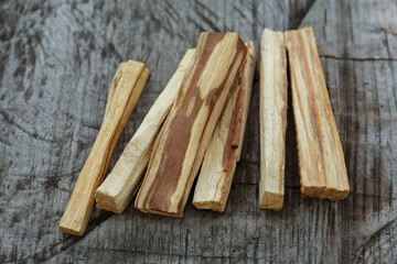 Palo santo sticks on wooden table, closeup