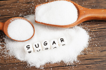 SUGAR, sweet granulated sugar with text, diabetes prevention, diet and weight loss for good health.