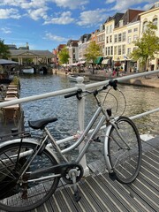 Beautiful view of bicycle on pedestrian bridge near canal in city