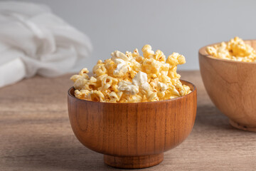 Popcorn in a wooden cup. Snacks.