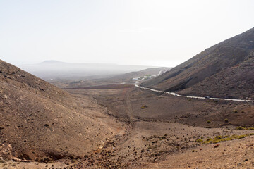 Natural landscape of Lanzarote. The road goes into the distance. View from the observation deck - Mirador De Femes. Canary Islands. Spain.
