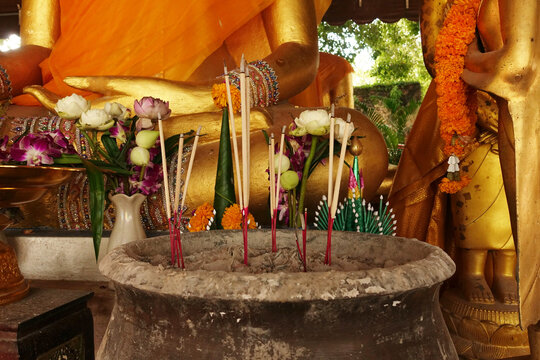 Incense sticks on joss stick pot are burning and oblation use for pay respect to Buddha statue,Ayutthaya province Thailand (Visakha Puja Day,Asalha Puja Day,Magha Puja Day concept)