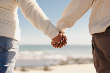 Couple holding hands at the beach