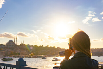 Tourist taking photo of Istanbul at sunset. Travel to Istanbul background photo