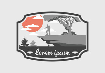 Mountain climbers standing on the edge of a cliff under a shady tree