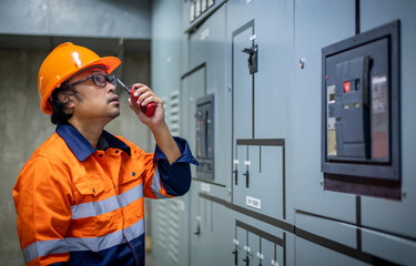 The engineer checking and inspecting at MDB panel .he working with electric switchboard to check...