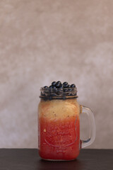 foreground cold fruit juices or ice cream in glass jars and tapioca pearls watermelon and melon milkshake with beige background and slate stone table space for text