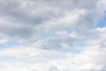 White clouds on the blue sky as a background.
