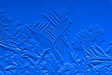 Drawings of ice on blue glass.