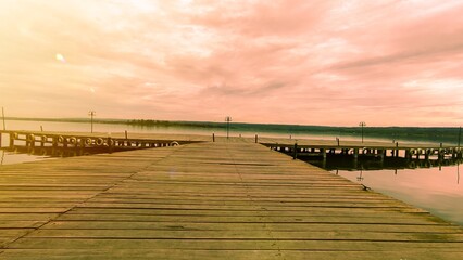 A peaceful in the wooden pier by the lake at sunset